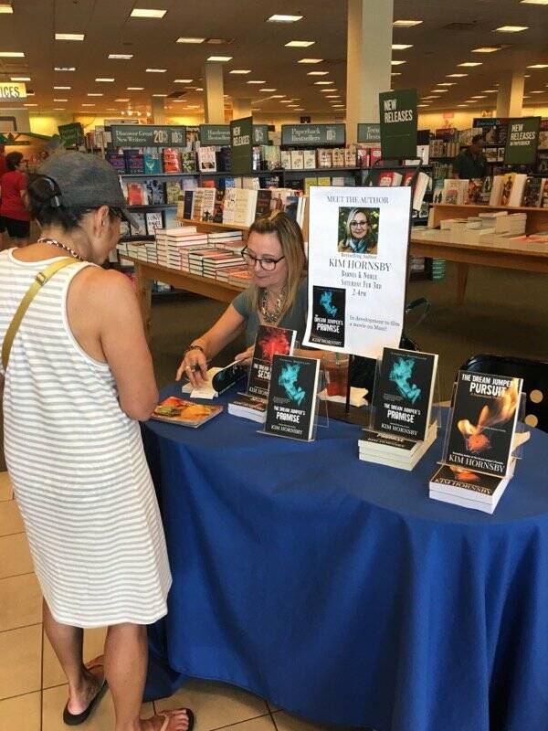Kim Hornsby signs some of her books at an author event in a Barnes & Noble. (Photo provided)