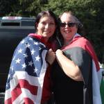 (Photo by Kylee Duggar) Mary Magennis, right, wrapped in the Palestinian flag, next to Autumn Bowers with the American flag. The two women with different political viewpoints met Saturday and found common ground.