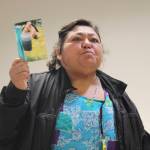 Photo by Marina Blatt
Concepción Contreras holds up a photo of her mobile homes dirty water.