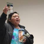 Concepción Contreras shows photos of the health affects she has suffered from the poor-quality water. (Photo by Marina Blatt)