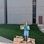 (Photo provided) Alice Irwin stands in front of the Fairfax County Courthouse, where she hosted her book drive.