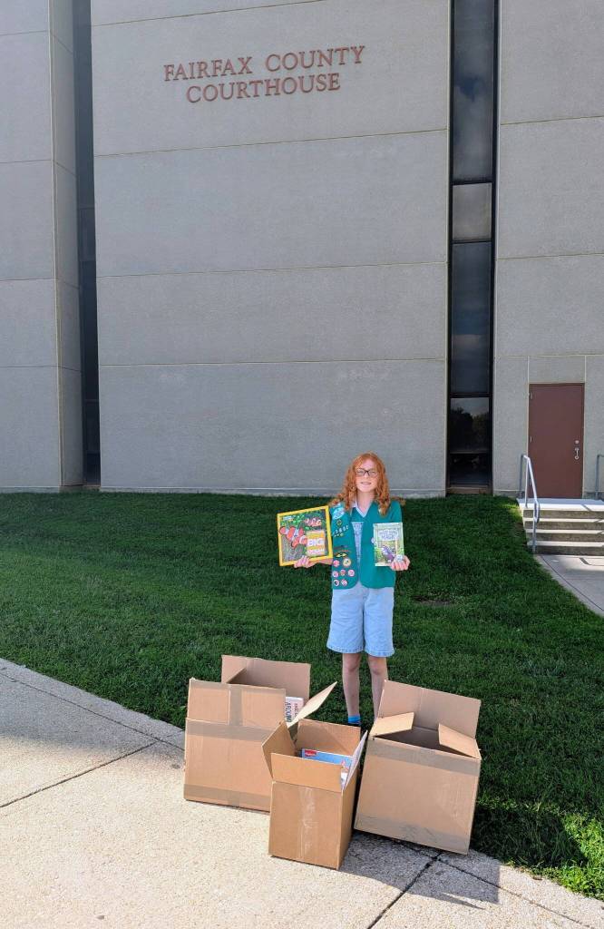 (Photo provided) Alice Irwin stands in front of the Fairfax County Courthouse, where she hosted her book drive.