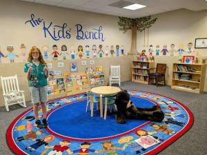 Photo provided
Alice Erwin smiles in the kids' reading area at a courthouse, which she helped to stock.