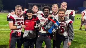 Malachi Somes (holding The Bucket) celebrates a birthday win with his teammates. (Megan Rickner photo)