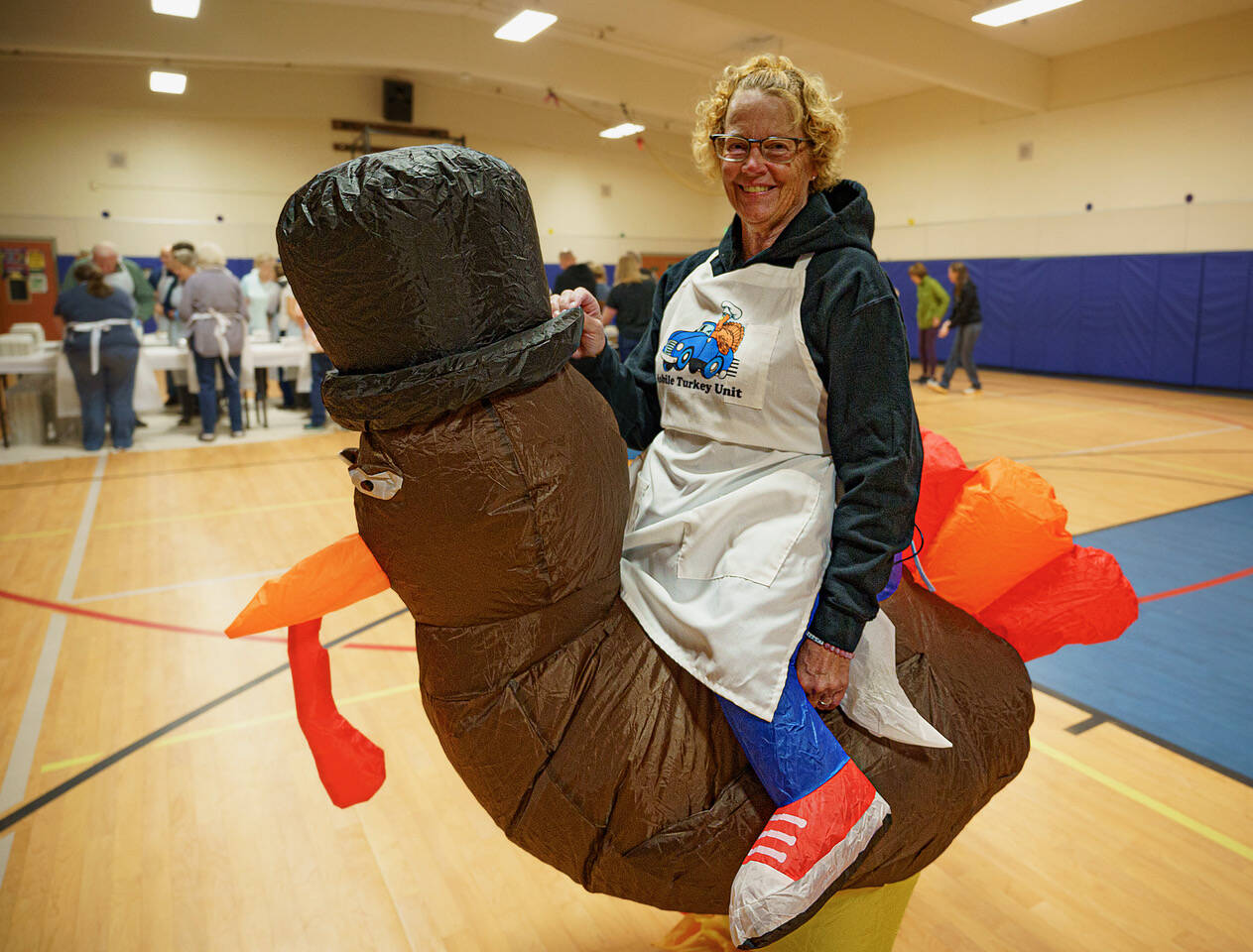Photo by David Welton
Lana Johnson wears an inflatable turkey costume. As a volunteer last year for Mobile Turkey Unit, she directed traffic into the parking lot for an orderly pick-up of 696 meals.