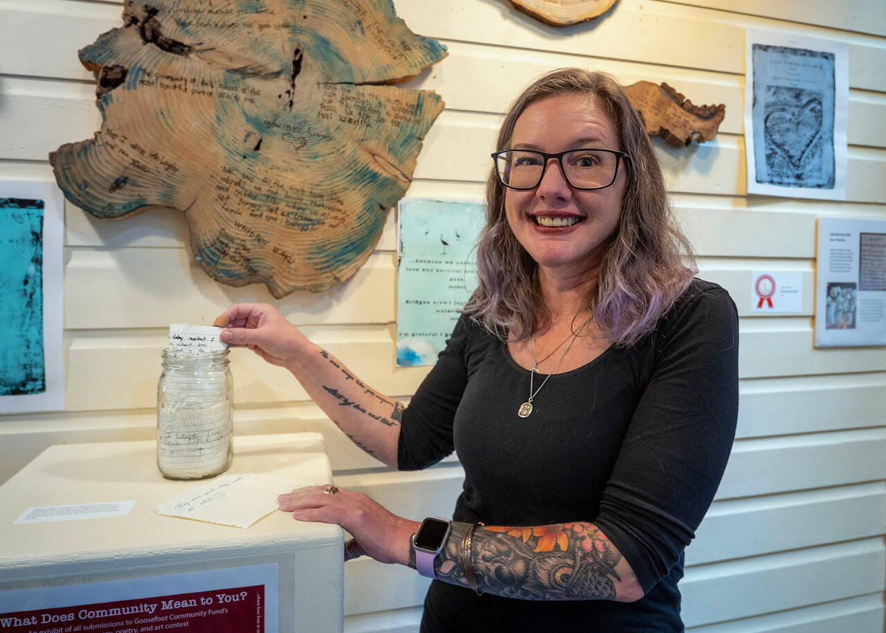 (Photo by David Welton) Kara Peabody shows the original jar of messages she collected about community on South Whidbey.