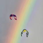 (Photo by Nichol Redfearin) Kites float in front of a vibrant rainbow.