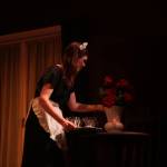 Elizabeth Rud playing Edith arranges flowers on a table. (Photo by Marina Blatt)