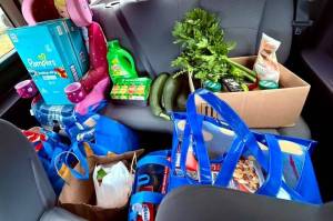 Krista Vanicsek loads her car up with produce for the food pantry. (Photo provided)