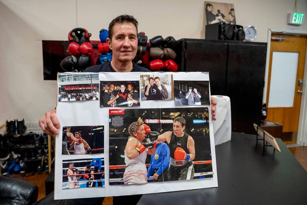 Dakota Stone holds up a board of photos cut from magazines featuring her fight with Christy Martin. (Photo by David Welton)
