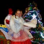 Mrs. Claus waves at onlookers after catching a ride with South Whidbey Fire/EMS. (Photo by David Welton)