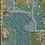 Photo provided
An aerial photo of the 33-acre property involved in the agreement taken in 2024, included in materials provided to the council; the stars indicate the location of the three undeveloped parcels in question.