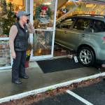 Photo provided by John Norris
A car crashed into Wild Birds Unlimited in Freeland last week. Owner Noel NicFergusson looks on while on the phone.