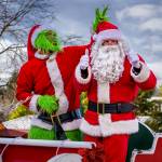 Photo by David Welton
The Grinch pulls a devious prank on Santa, giving him bunny ears at the Langley parade.