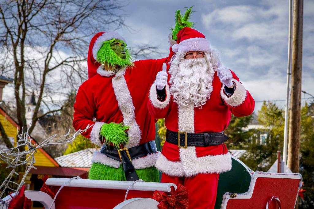 Photo by David Welton
The Grinch pulls a devious prank on Santa, giving him bunny ears at the Langley parade.