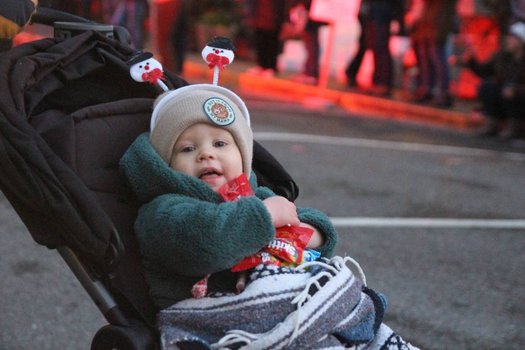 Photo by Marina Blatt
A toddler holds on tight to his prized possesions: candy passed out at the Coupeville parade.