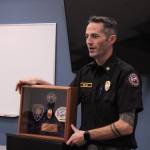 (Photo by Allyson Ballard) Fire Chief Jerry Helm presented Engle with several gifts, including a commemorative shadowbox.