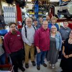 (Photo by David Welton) The new and old owners of Matts Import Haven are flanked by the auto repair shops dedicated team of staff members.