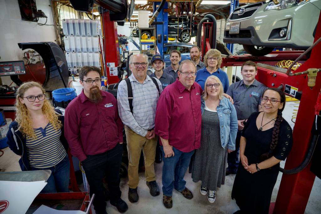 (Photo by David Welton) The new and old owners of Matts Import Haven are flanked by the auto repair shops dedicated team of staff members.