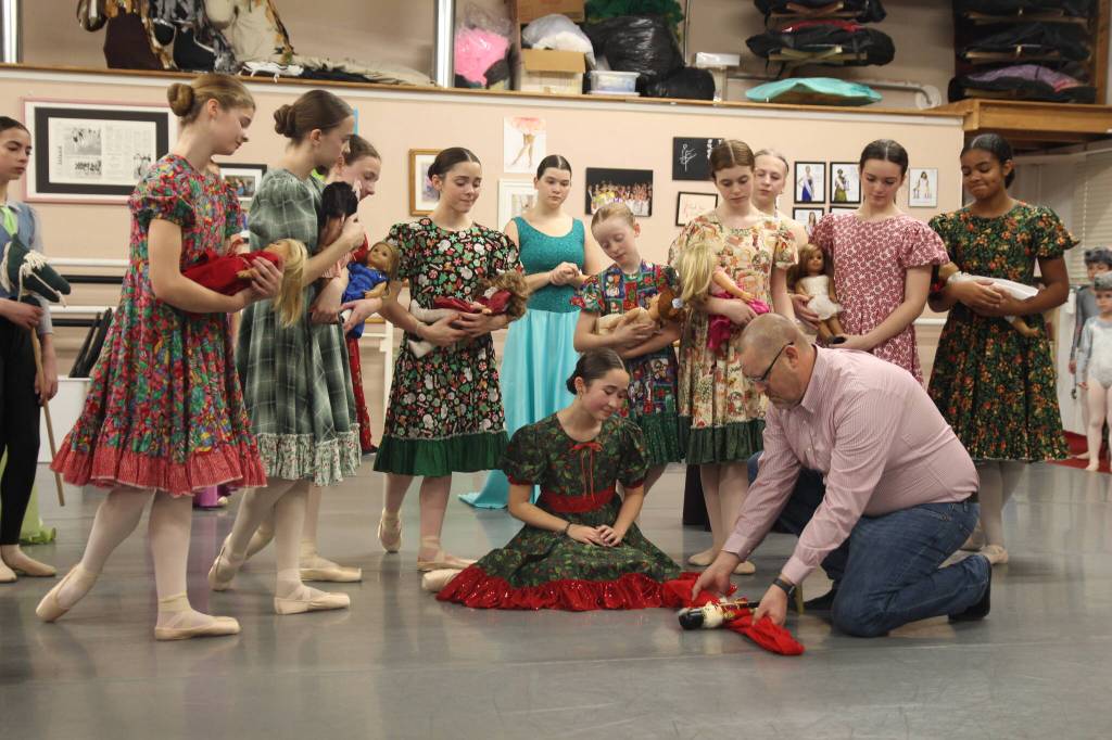 Trevor Reed, playing Drosselmeyer, repairs the broken nutcracker to Claras delight. Hannah Brackeen, age 15, plays the role of Clara, expertly combining acting with dancing.