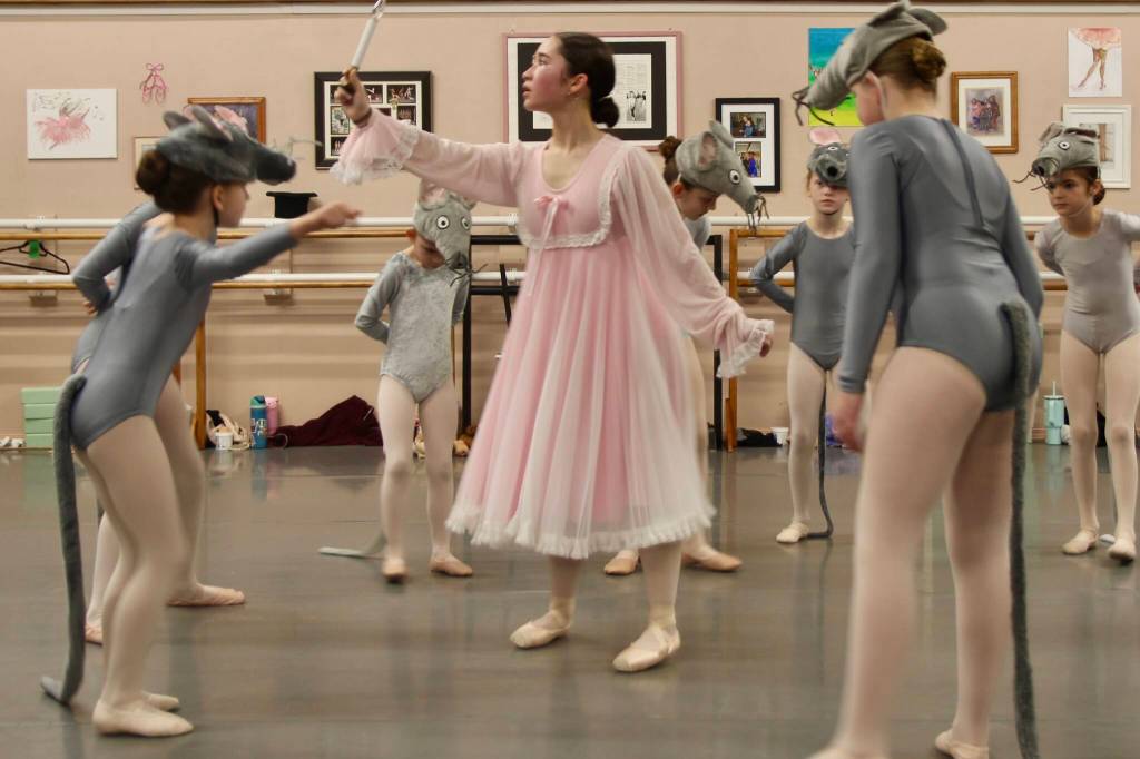 Hannah Brackeen, age 15, in the role of Clara, looks for her nutcracker in her sleeping gown as she gets surrounded by mice.