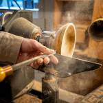 Photo by David Welton. Large chisels are used to carve decorative lines all around the bowl.