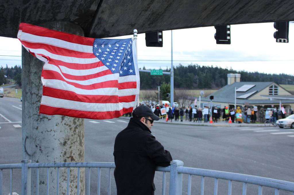(Photo by Allyson Ballard) Demonstrators filled the sidewalks of the intersection and accumulated on the pedestrian bridge as well.