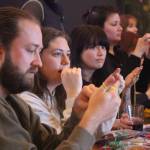 Photo by Marina Blatt. In between sips, bar visitors listen attentively as they learn how to make finger crochet bows. Every presentation during Show and Tell night was equally as weird and intriguing.