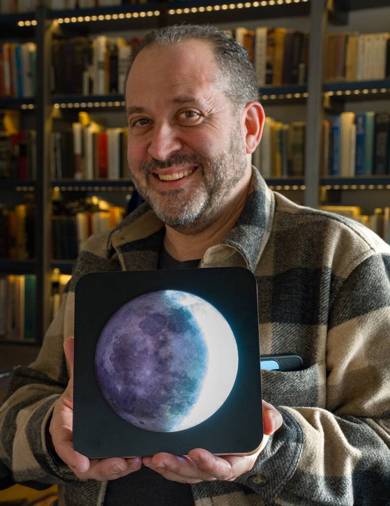 (Photo by David Welton) Dorian Garson with the LunaKron, which shows a waxing crescent moon on Feb. 18.