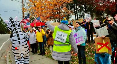 Photo by Greg Jensen. A peacekeeper directs the crowd during a protest on Whidbey. Beyond crowd safety, peacekeepers also assist participants who are overheated, injured or in need of support and coordinate with law enforcement when necessary.