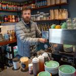 Photo by David Welton. Sterling Jones makes an espresso shot for a cappuccino at Salty Sea Coffee in Langley, one of three locations operated by Jones and his wife, Allie.