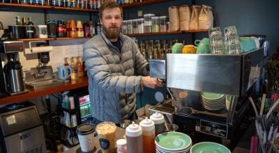 Photo by David Welton. Sterling Jones makes an espresso shot for a cappuccino at Salty Sea Coffee in Langley, one of three locations operated by Jones and his wife, Allie.