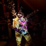 Photo and art by res plumata. A life-size body with wings stretching from its fragile paper skin, glows from the inside, pieced together from MRIs, ultrasounds and medical records.