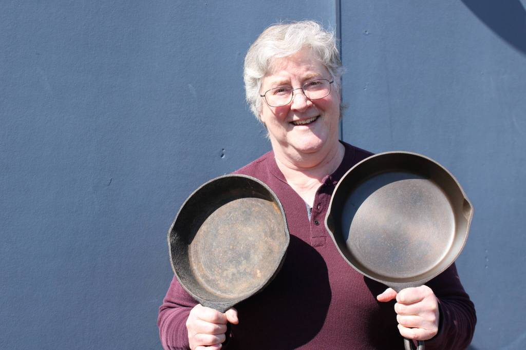 Photo by Allyson Ballard. Robin Bridges estimates she has restored 200 cast iron skillets to their former glory, and she will be selling some at the upcoming market.