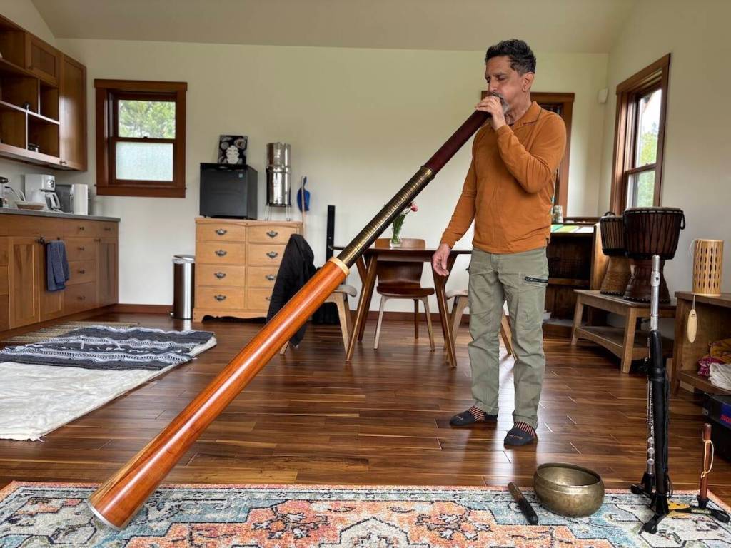 Photos by Kate Poss. Joseph Sanchez plays a didgeridoo as part of a south bath.