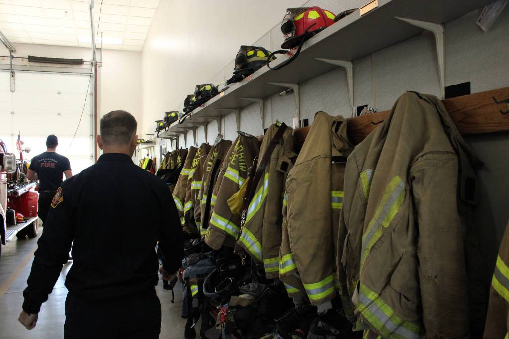 Photo by Allyson Ballard. Firefighters gear hangs openly in the apparatus bay at Station 81, whereas in Station 82, gear has its own locker.