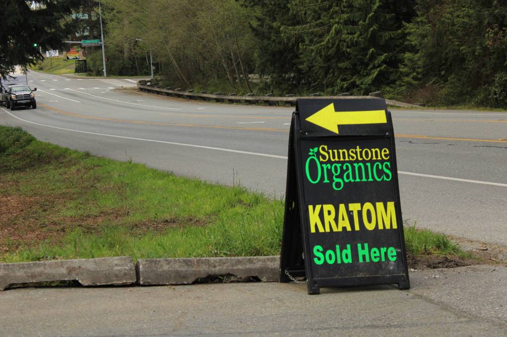Photo by Allyson Ballard. A store near Cranberry Lake in Oak Harbor advertises the sale of kratom with a neon and black sign.