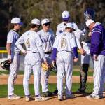 Photo by Kevin Foy
Players gather on the mound on March 30.