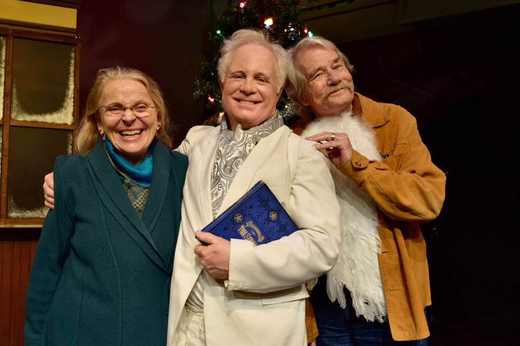 Photo by Patricia Guthrie. Longtime actor, stage manager and set designer, the late Jim Scullin played Clarence, the angel in search of wings, in the 2019 WICA production of Its a Wonderful Life. Hes surrounded by Judith Walcutt and David Ossman, who directed the play.