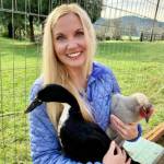 Photo provided. Heidi Island loves otters the most, but she carries her devotion for all animals to her farm in Oregon. The author smiles with her duck, Pepper, in one arm and her chicken, Lulu, in the other.