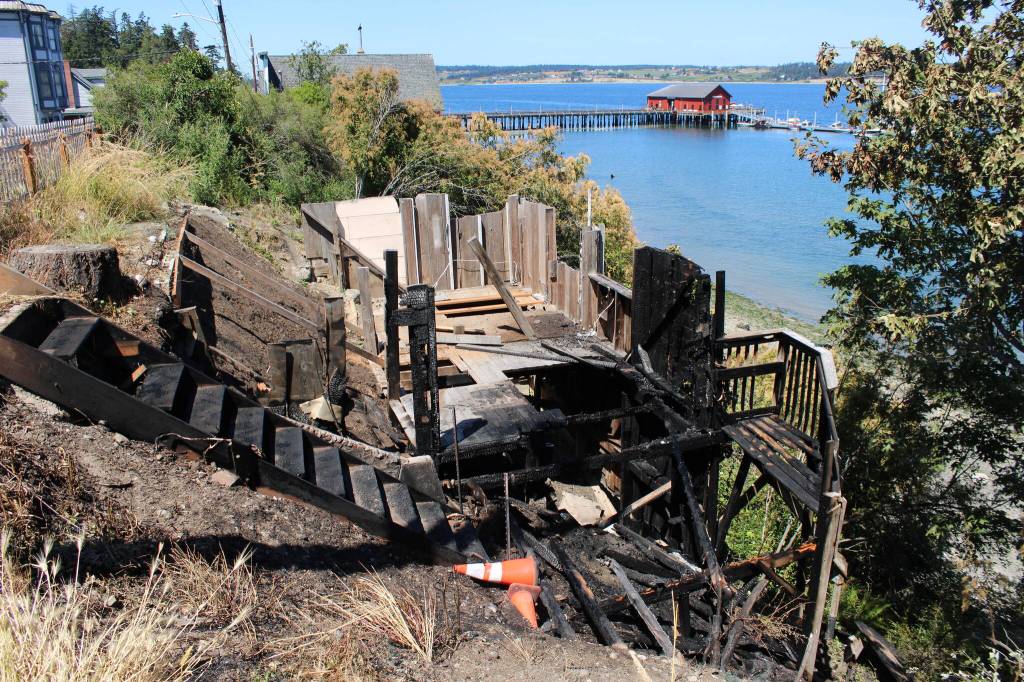 (Photo by Allyson Ballard) What caused the remnants of a relocated historic building to burn in Coupeville early Sunday morning is still unknown, but remains of fireworks were found nearby.