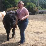 Photo by Marina Blatt. Lilly Kline, an 18-year-old, jokes that her steer is a stinker, but after more than a decade of raising livestock, she still loves him.